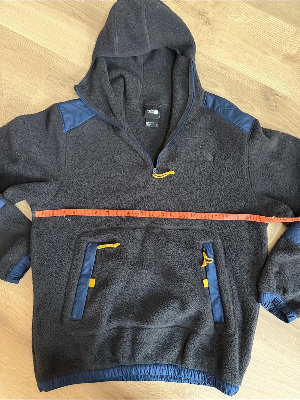 The North Face Black Fleece Hoodie with Blue Panels and Orange Accents